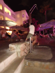 Max dancing at the main swimming pool at the Prinsotel Alba Hotel Apartamentos, by night