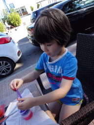 Max playing with slime at the Restaurante Cafetería Mediterraneo at the Carrer Marquès de Comillas street