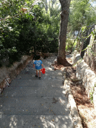 Max with a bucket on the staircase to the east side of the Cala d`Or beach