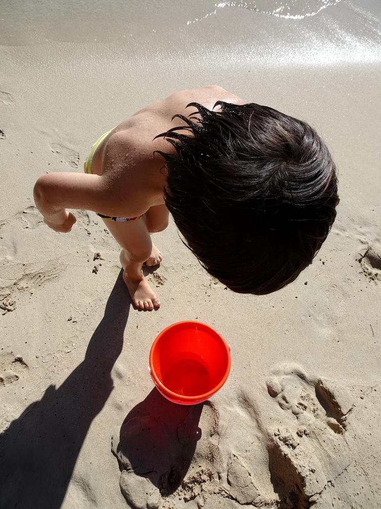 Max with a fish in our bucket at the Cala d`Or beach