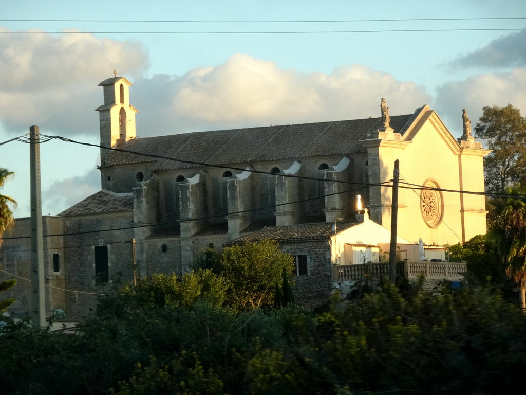 The north side of the Esglesia D`es Carritxó church at the town of Es Carritxó, viewed from the rental car on the Ma-4016 road