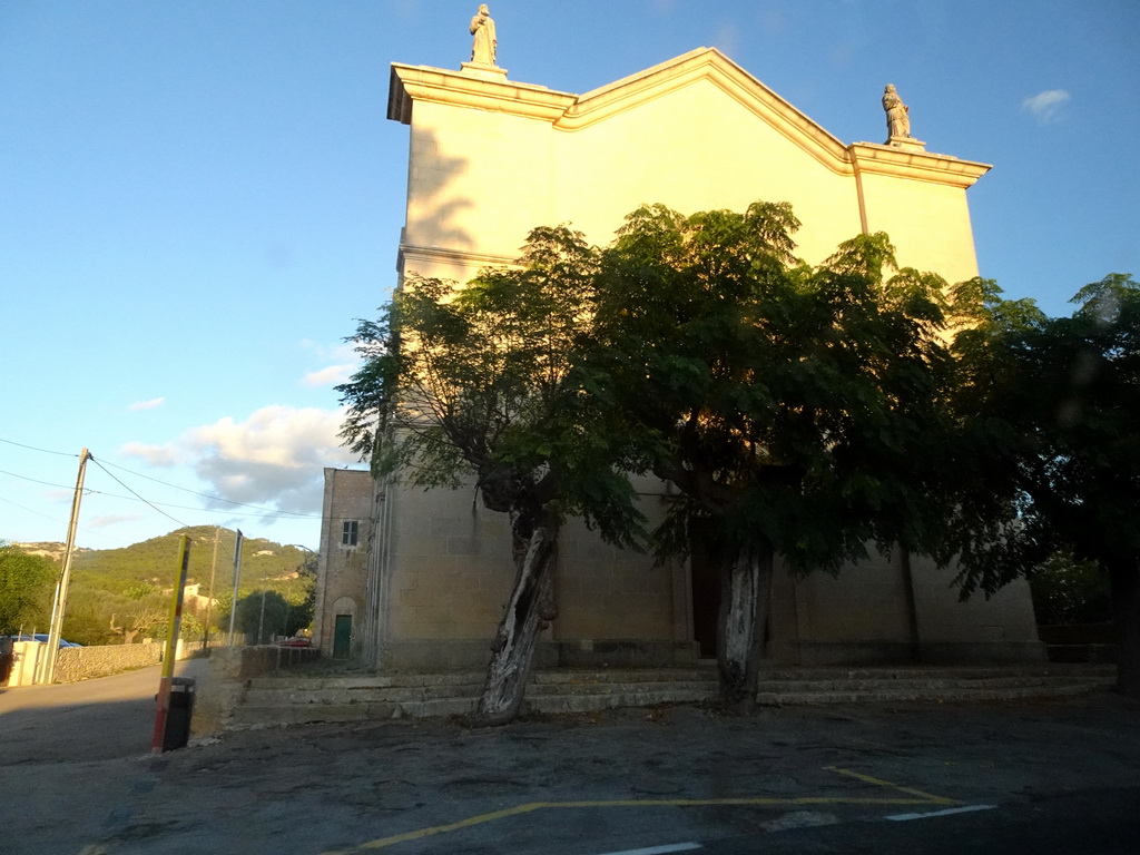 The west side of the Esglesia D`es Carritxó church at the town of Es Carritxó, viewed from the rental car on the Ma-4016 road