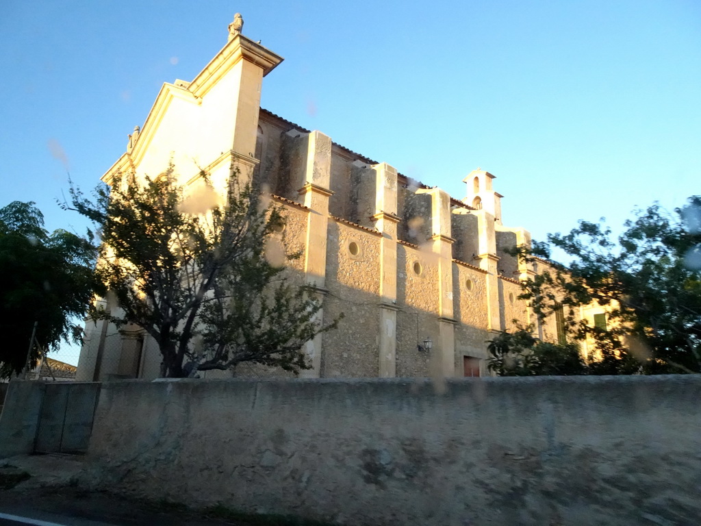 The southwest side of the Esglesia D`es Carritxó church at the town of Es Carritxó, viewed from the rental car on the Ma-4016 road