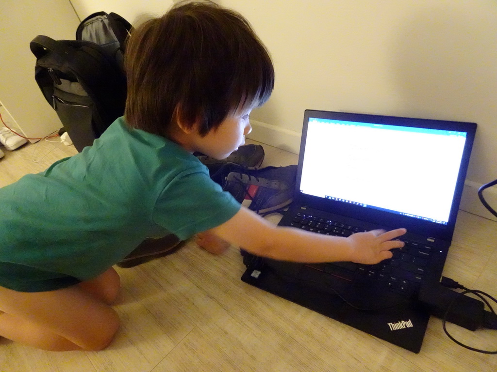 Max playing with a laptop at our living room at the Prinsotel Alba Hotel Apartamentos