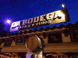 Sign at the facade of the La Bodega restaurant at the Carrer d`en Andreu Roig street, by night