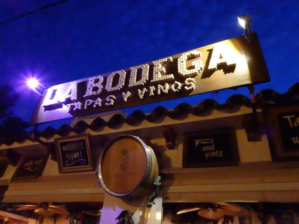 Sign at the facade of the La Bodega restaurant at the Carrer d`en Andreu Roig street, by night