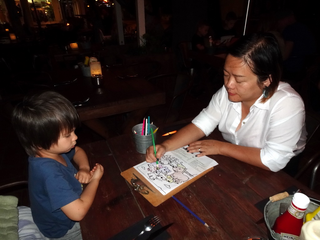Miaomiao and Max colouring a drawing at the Restaurant Meatclub Mallorca at the Carrer d`en Andreu Roig street