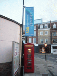 Flag on 800 years University of Cambridge, and telephone booth, at Emmanuel Street