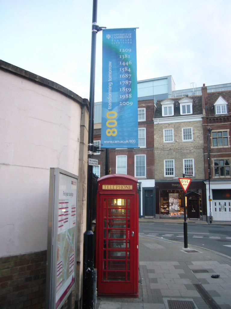 Flag on 800 years University of Cambridge, and telephone booth, at Emmanuel Street