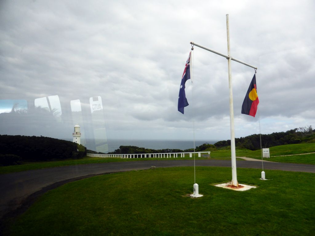 Australian and Aboriginal flags and the Cape Otway Lighthouse, viewed from our tour bus