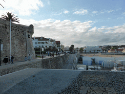 The Passeio Dona Maria Pia walkway, the northeast corner of the wall of the Cascais citadel and the beach at the Cascais harbour, viewed from the Clube Naval de Cascais