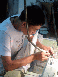 Craftsman working on jewelry in the jade workshop at Jingyin Road