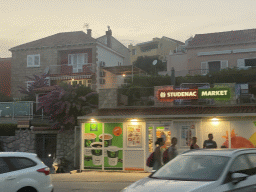 Front of the Studenac Market store at the town of Mlini, viewed from the bus from Dubrovnik Airport to the Grand Hotel Park on the D8 road, at sunset