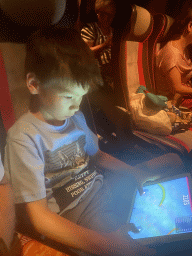 Max playing on the iPad in the tour bus from Perast on the D8 road near the town of Zvekovica