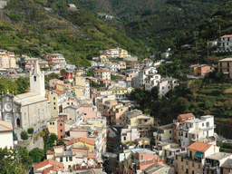 The upper side of the town with the Via Colombo street and the Chiesa di San Giovanni Battista church, viewed from the Riomaggiore Castle