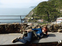 Miaomiao at the Riomaggiore Castle with a view on the new town and the Via dell`Amore path to Manarola