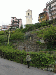 Miaomiao at the Via Discovolo street at Manarola with the bell tower of the Chiesa di San Lorenzo church