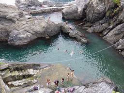 People swimming in the harbour of Manarola