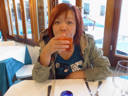 Miaomiao with a drink at the Marina Piccola restaurant at the Via Lo Scalo street at Manarola