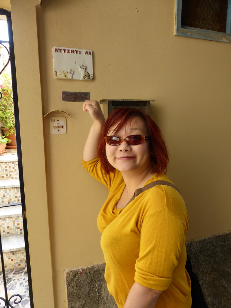 Miaomiao with a cat sign at a house at the square behind the Oratory of San Caterina at Corniglia