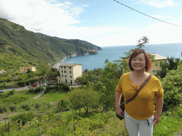 Miaomiao with houses and wine fields at the east side of Corniglia and a view on Manarola from the path from Corniglia to Manarola