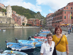 Tim and Miaomiao with the harbour of Vernazza and the Piazza Marconi square with the Chiesa di Santa Margherita d`Antiochia church