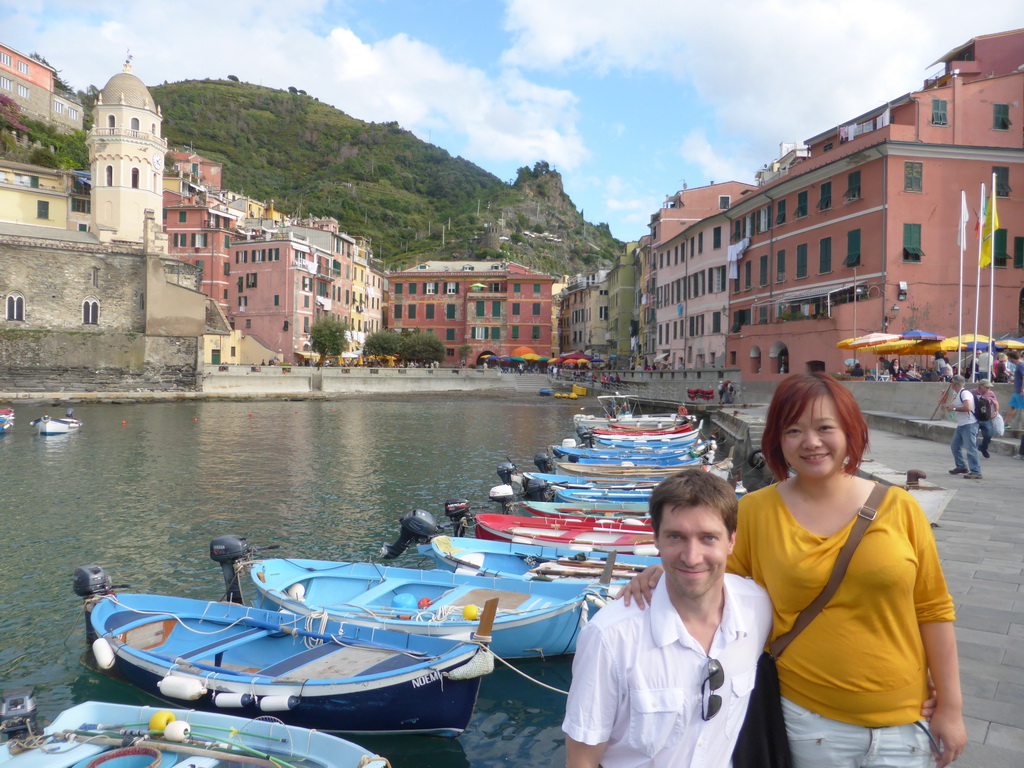 Tim and Miaomiao with the harbour of Vernazza and the Piazza Marconi square with the Chiesa di Santa Margherita d`Antiochia church