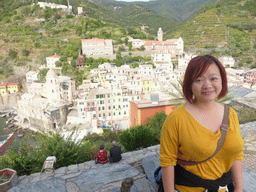 Miaomiao at the Doria Castle at Vernazza, with a view on the town center with the Chiesa di Santa Margherita d`Antiochia church and the Santuario di Nostra Signora di Reggio sanctuary