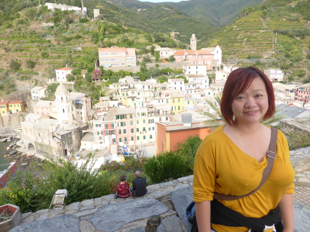 Miaomiao at the Doria Castle at Vernazza, with a view on the town center with the Chiesa di Santa Margherita d`Antiochia church and the Santuario di Nostra Signora di Reggio sanctuary