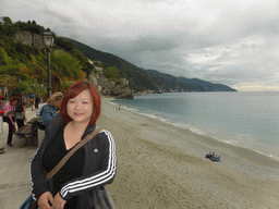 Miaomiao at the beach of the new town of Monterosso al Mare and the Torre Aurora tower