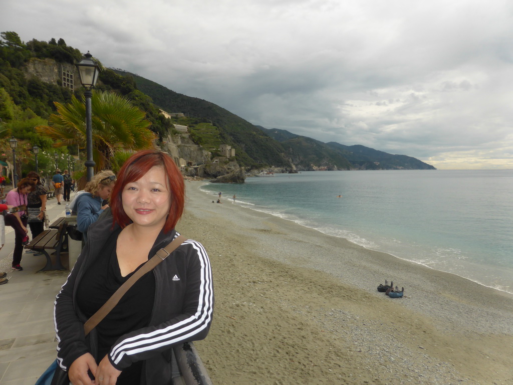 Miaomiao at the beach of the new town of Monterosso al Mare and the Torre Aurora tower