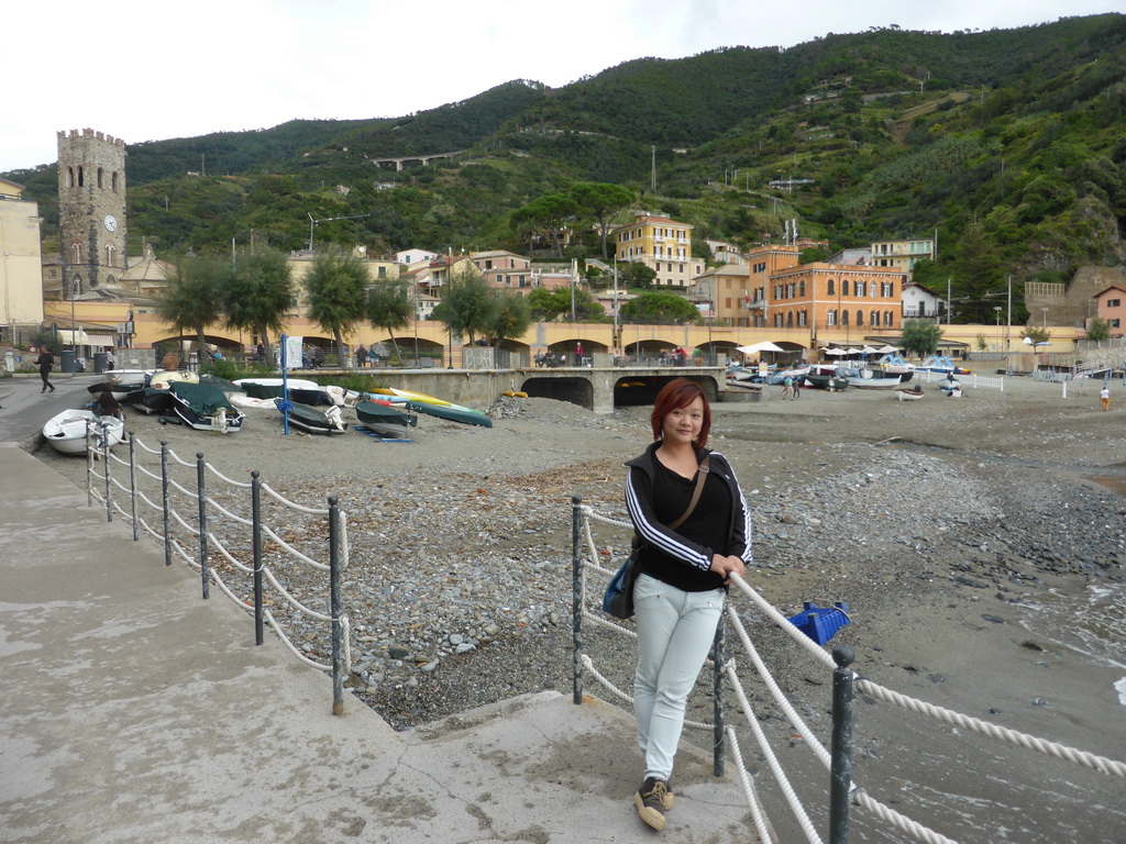 Miaomiao with the harbour, railway and beach of Monterosso al Mare and the tower of the Chiesa di San Giovanni Battista church