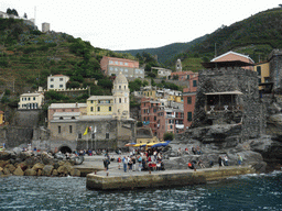 The harbour of Vernazza, the Piazza Marconi square, the Chiesa di Santa Margherita d`Antiochia church and the Doria Castle, viewed from the ferry to Manarola