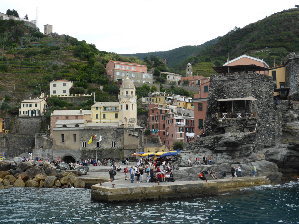 The harbour of Vernazza, the Piazza Marconi square, the Chiesa di Santa Margherita d`Antiochia church and the Doria Castle, viewed from the ferry to Manarola
