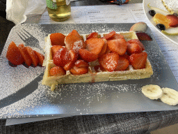 Waffle with strawberries at the terrace of the La Maison De La Gaufre restaurant