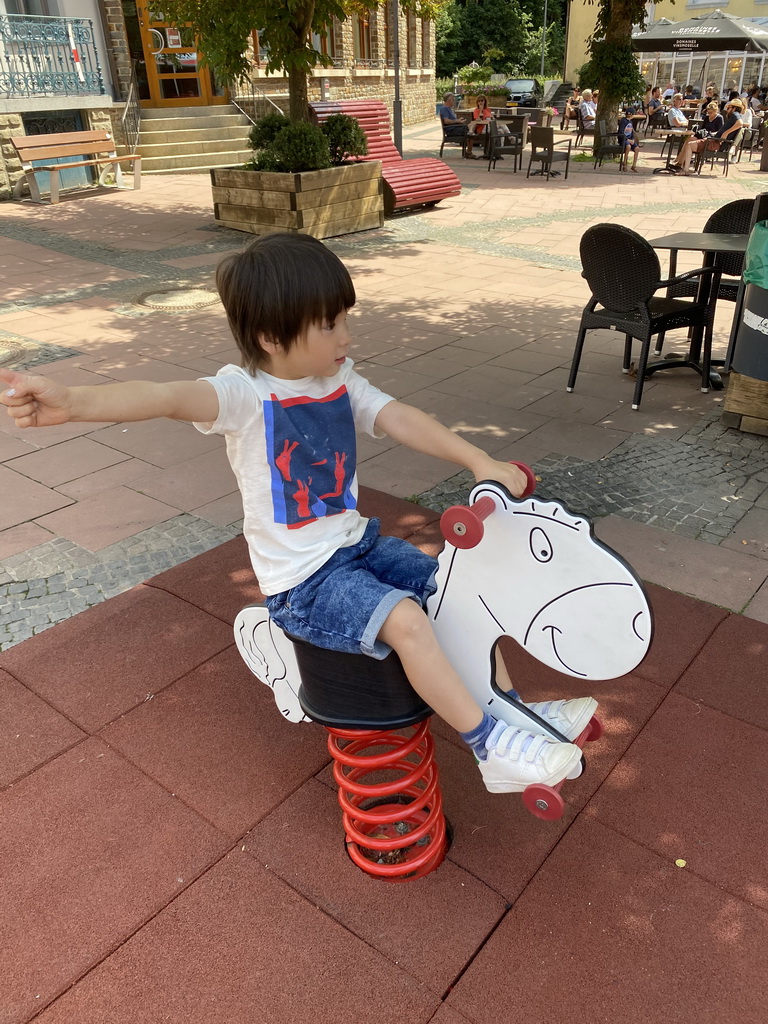 Max on a seesaw at the Place du Marché square