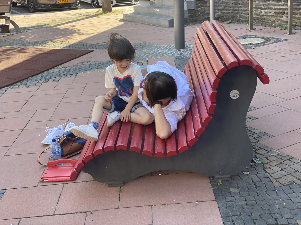 Miaomiao and Max on a bench at the Place de Liberation square