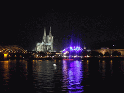 The Hohenzollernbrücke railway bridge over the Rhein river, the Cologne Cathedral, the Musical Dome Köln and the tower of the Basilica church of St. Ursula, viewed from the Kennedy-Ufer street, by night