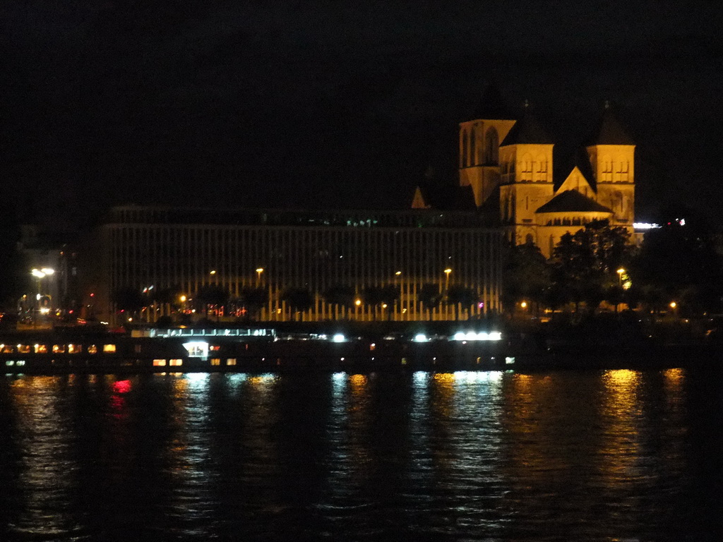 The Institut der Deutschen Wirtschaft building and St. Kunibert`s Church, viewed from the Kennedy-Ufer street, by night