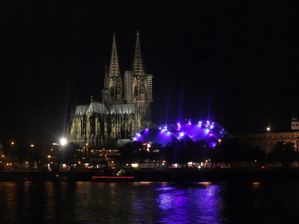 The Rhein river, the Cologne Cathedral, the Musical Dome Köln and the tower of the Basilica church of St. Ursula, viewed from the Kennedy-Ufer street, by night