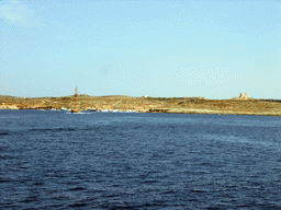 Boats at the Blue Lagoon (Bejn Il-Kmiemen) and St. Mary`s Tower, viewed from the Luzzu Cruises tour boat from Gozo to Comino