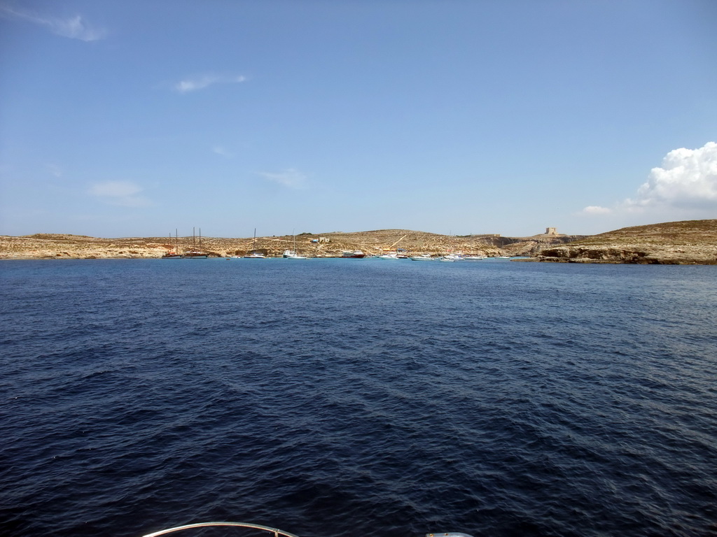 Boats at the Blue Lagoon and St. Mary`s Tower, viewed from the Luzzu Cruises tour boat from Gozo to Comino