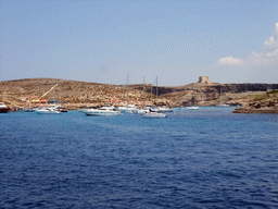 Boats at the Blue Lagoon and St. Mary`s Tower, viewed from the Luzzu Cruises tour boat from Gozo to Comino