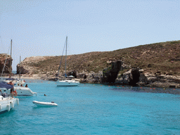 Boats and swimmers at the Blue Lagoon and Cominotto island, viewed from the Luzzu Cruises tour boat from Gozo to Comino