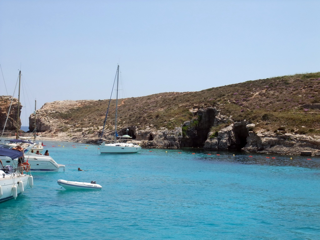 Boats and swimmers at the Blue Lagoon and Cominotto island, viewed from the Luzzu Cruises tour boat from Gozo to Comino