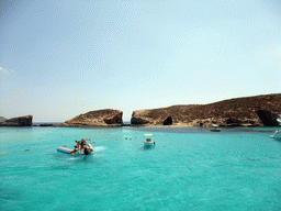 Boats and swimmers at the Blue Lagoon and Cominotto island, viewed from the Luzzu Cruises tour boat from Gozo to Comino