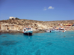 Boats at the Blue Lagoon, viewed from the Luzzu Cruises tour boat from Comino to Malta