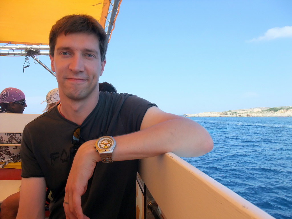 Tim on the Luzzu Cruises tour boat from Comino to Malta, with a view on the north coast of Comino