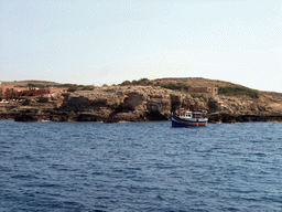 Boat at the north coast of Comino and the Comino Hotel, viewed from the Luzzu Cruises tour boat from Comino to Malta