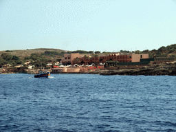 Boat at the north coast of Comino and the Comino Hotel, viewed from the Luzzu Cruises tour boat from Comino to Malta
